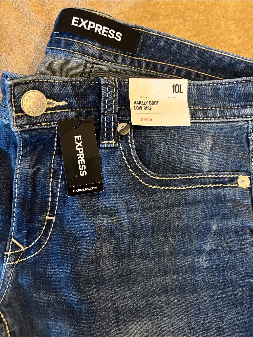 Express Barely Boot Low Rise Jeans in dark blue with white stitching